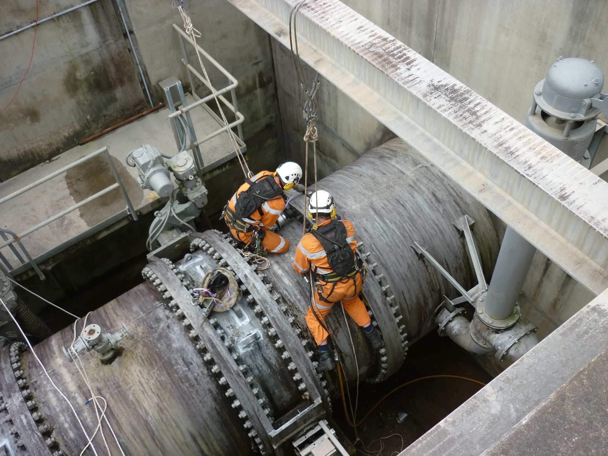 Men using impact rattle guns on mining project
